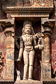 The great Chola temples of Tamil Nadu - The Airavatesvara temple of Darasuram. Figure of deity framed in niche of the south wall of the sanctuary (Bhiksatana).